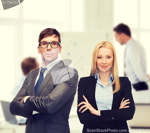 Image of businessman and businesswoman in the front of team