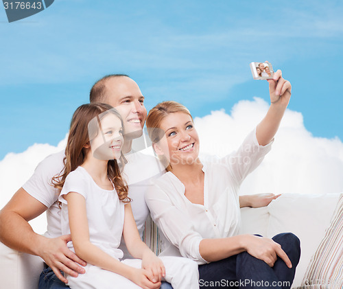 Image of happy family with camera at home