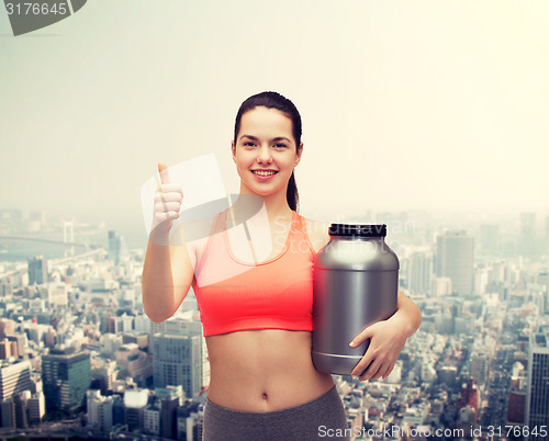 Image of teenage girl with jar of protein showing thumbs up