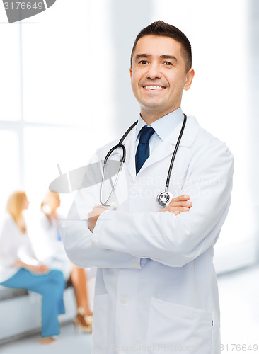 Image of smiling male doctor in white coat at hospital