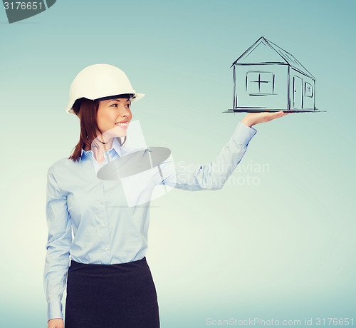 Image of young smiling businesswoman in white helmet