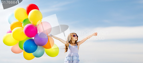 Image of happy girl with colorful balloons