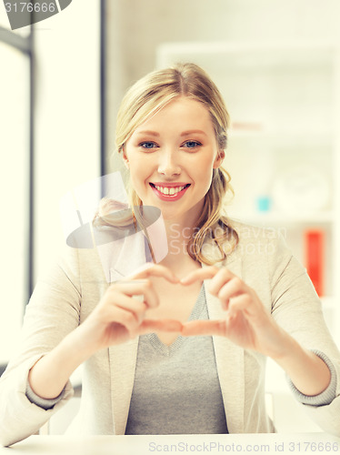 Image of young woman showing heart sign
