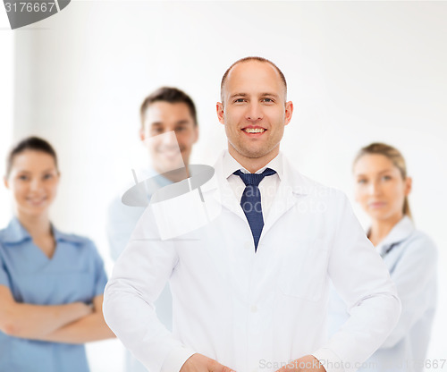 Image of smiling male doctor in white coat