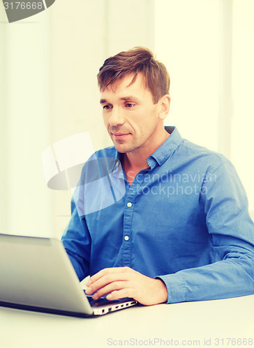 Image of man working with laptop at home