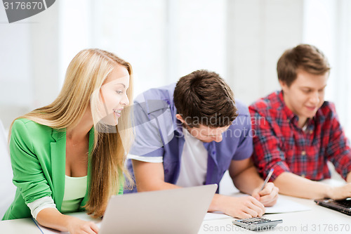 Image of students writing test or exam in lecture at school