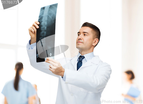 Image of male doctor looking at x-ray in hospital