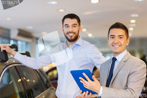 Image of happy man with car dealer in auto show or salon