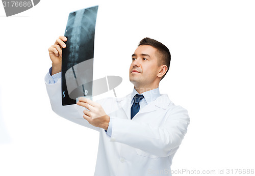 Image of male doctor in white coat looking at x-ray
