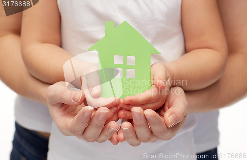 Image of close up of woman and girl hands with paper house