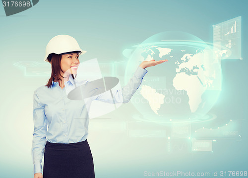 Image of young smiling businesswoman in white helmet