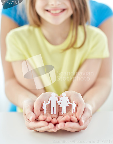 Image of close up of woman and girl hands with paper family