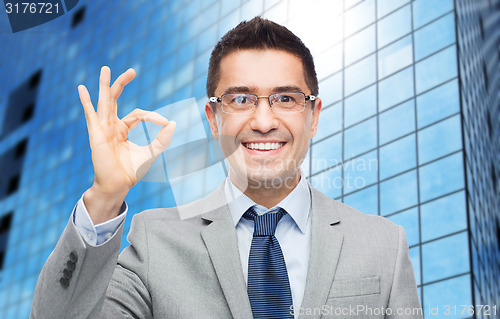 Image of happy smiling businessman in eyeglasses and suit