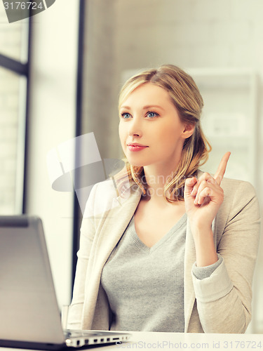 Image of woman with laptop and finger up