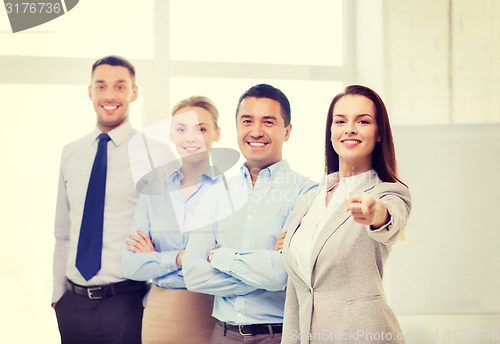 Image of businesswoman in office pointing finger at you