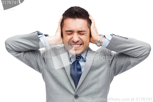 Image of businessman in suit having head ache