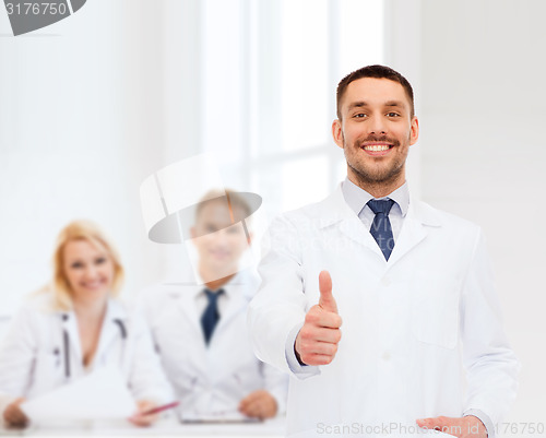 Image of smiling male doctor showing thumbs up