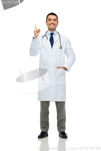 Image of happy male doctor in white coat pointing finger up