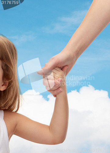 Image of close up of woman and little girl holding hands