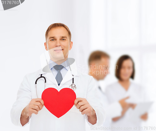 Image of smiling male doctor with red heart and stethoscope