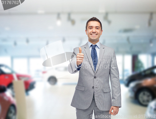 Image of happy man over auto show or car salon background