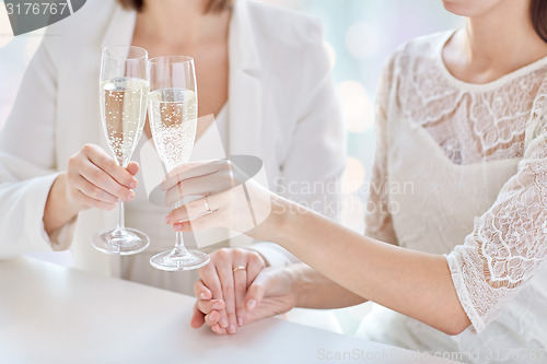 Image of close up of lesbian couple with champagne glasses