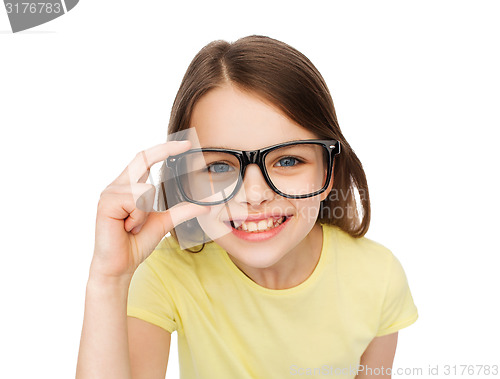 Image of smiling cute little girl in black eyeglasses