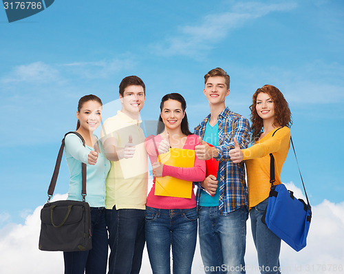 Image of group of smiling teenagers showing thumbs up