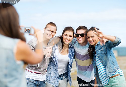 Image of teenagers taking photo outside