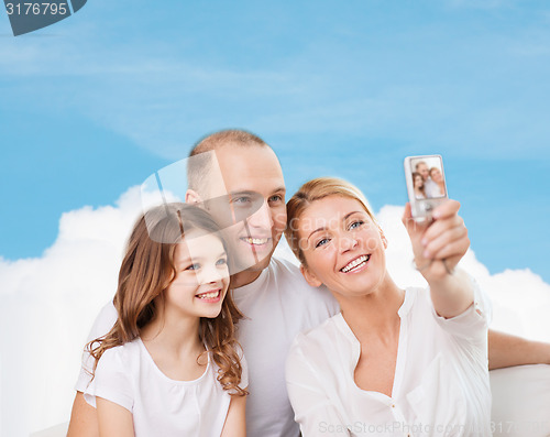 Image of happy family with camera at home