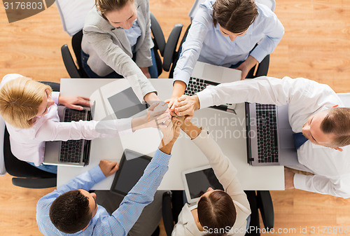 Image of close up of business team with hands on top