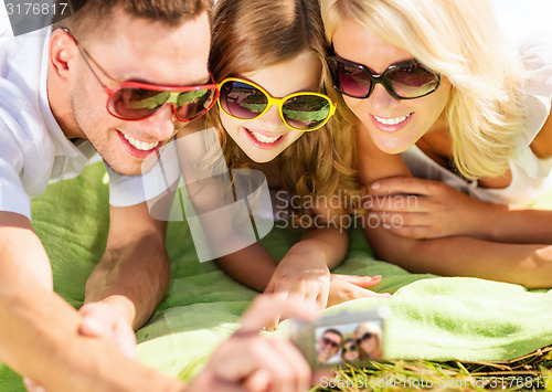 Image of happy family with camera taking picture