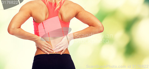 Image of close up of sporty woman touching her back