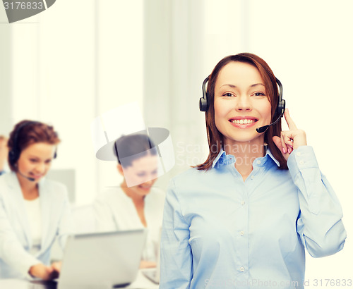 Image of friendly female helpline operator at office