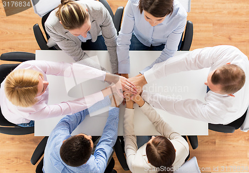 Image of close up of business team with hands on top