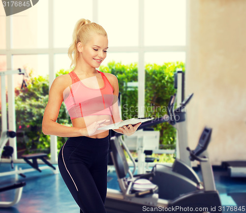 Image of smiling sporty woman with tablet pc computer