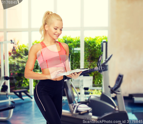 Image of smiling sporty woman with tablet pc computer