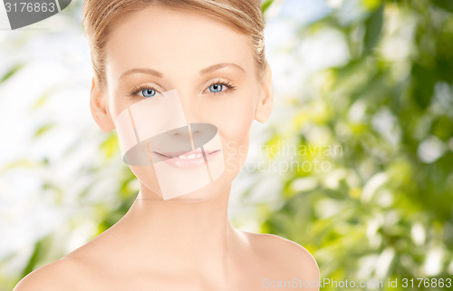 Image of beautiful young woman face over green background