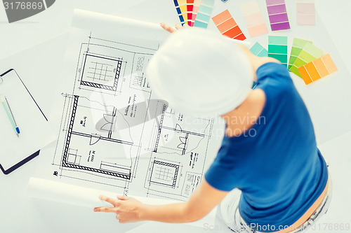 Image of woman with color samples and blueprint