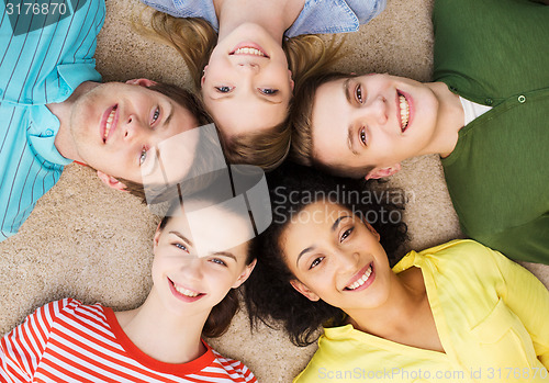 Image of group of smiling people lying down on floor