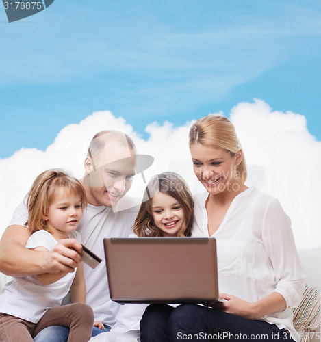 Image of happy family with laptop computer and credit card