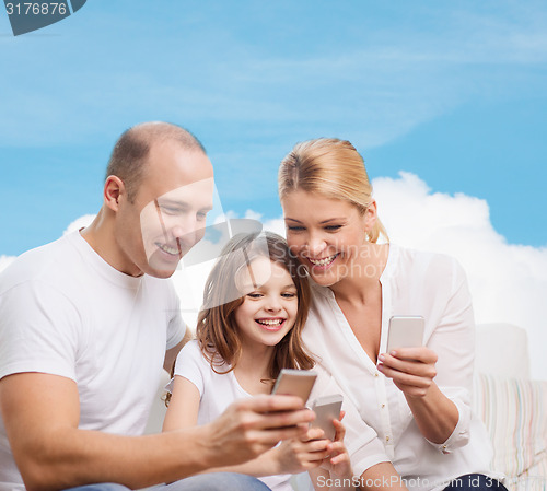 Image of happy family with smartphones
