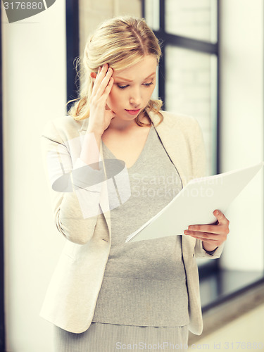 Image of worried woman with documents