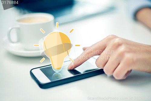 Image of close up of woman hand with smartphone and coffee