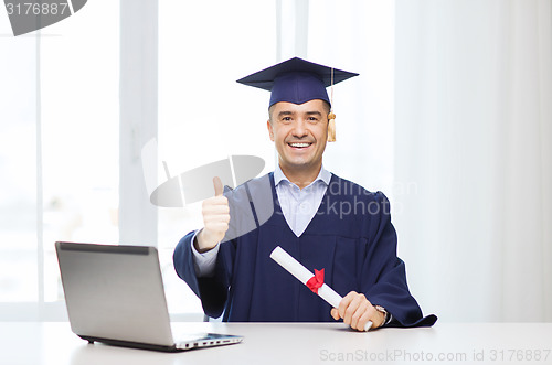 Image of smiling adult student in mortarboard with diploma