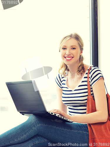 Image of happy teenage girl with laptop computer