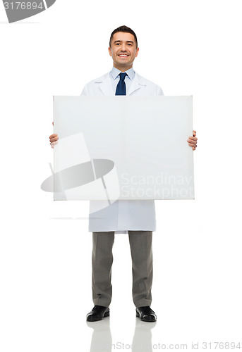 Image of smiling male doctor holding white blank board