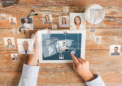 Image of close up of hands with tablet pc and network