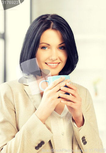 Image of lovely businesswoman with mug