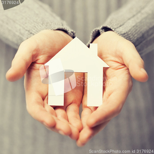 Image of man holding paper house